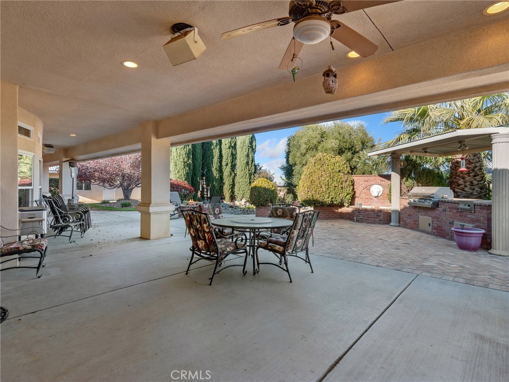 7139 Foley Road Oak Hills, CA 92344 - Photo 55 of 72 a dining room with furniture and a floor to ceiling window