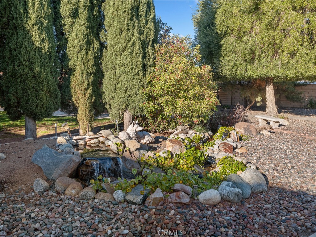 7139 Foley Road Oak Hills, CA 92344 - Photo 58 of 72 a view of a backyard with plants and a patio
