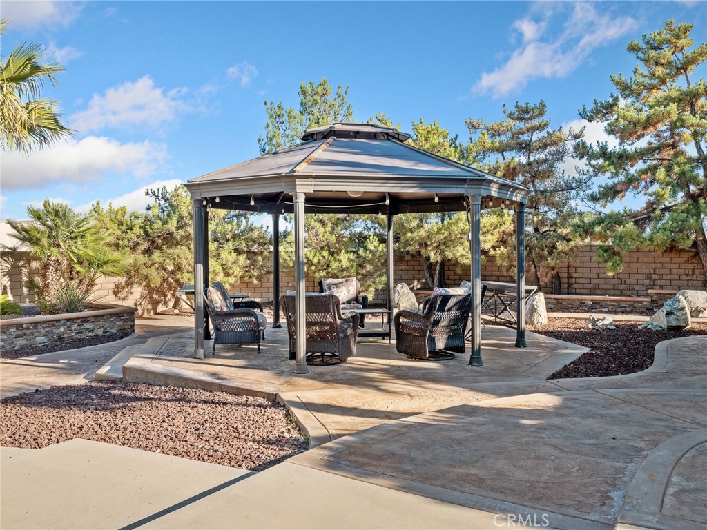 7139 Foley Road Oak Hills, CA 92344 - Photo 59 of 72 a view of a patio with a table and chairs under an umbrella