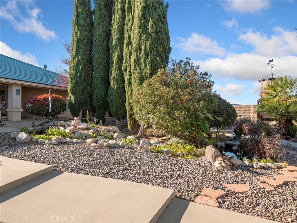 7139 Foley Road Oak Hills, CA 92344 - Photo 60 of 72 a front view of a house with a yard and sitting area