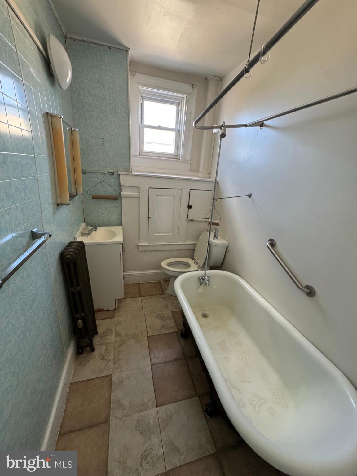 2826 Winchester Street Baltimore, MD 21216 - Photo 11 of 22 a bathroom with a tub sink and toilet