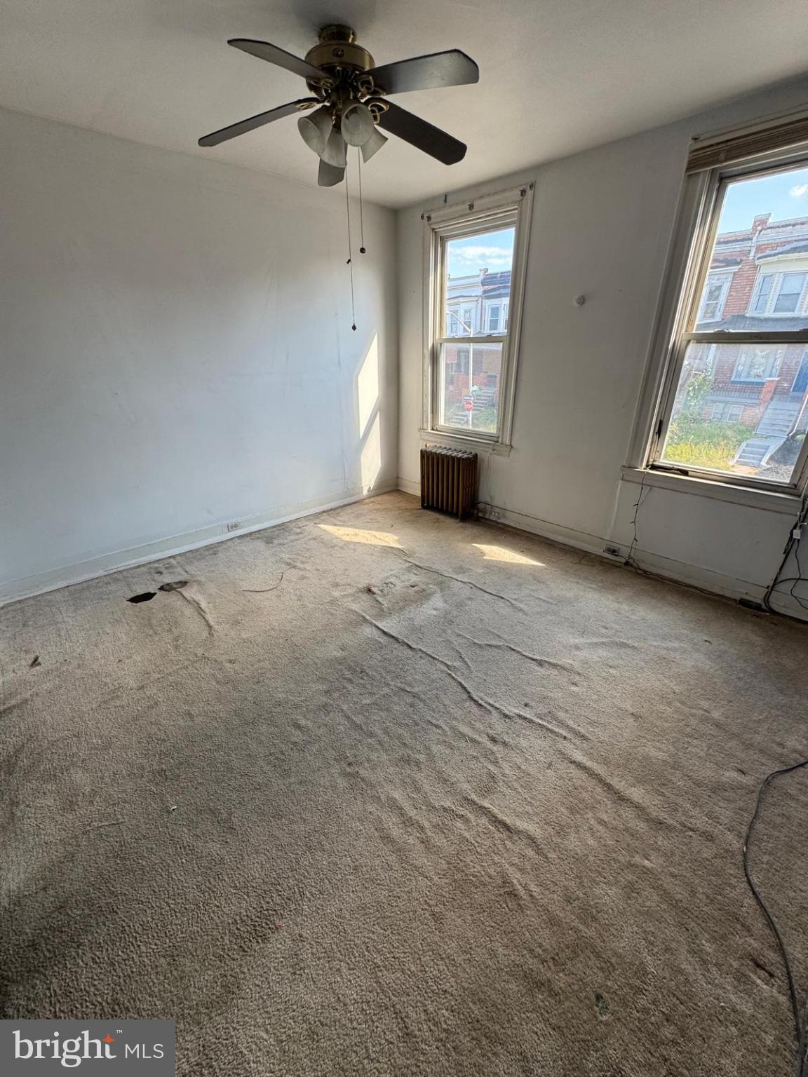 2826 Winchester Street Baltimore, MD 21216 - Photo 22 of 22 an empty room with windows and ceiling fan