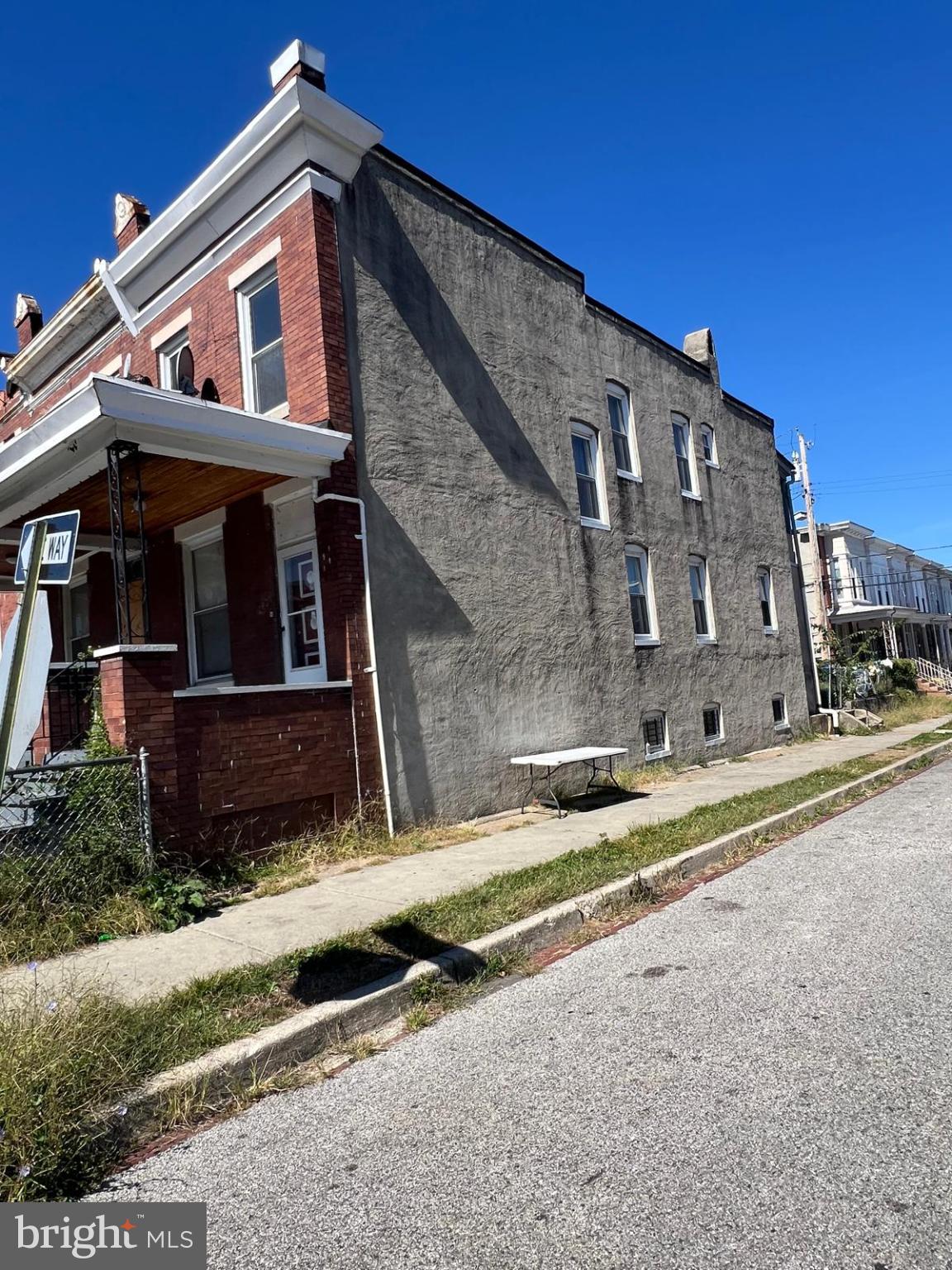 2826 Winchester Street Baltimore, MD 21216 - Photo 3 of 22 a view of a house with a small yard and wooden fence