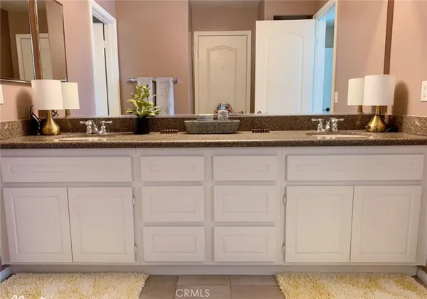 a bathroom with white cabinets