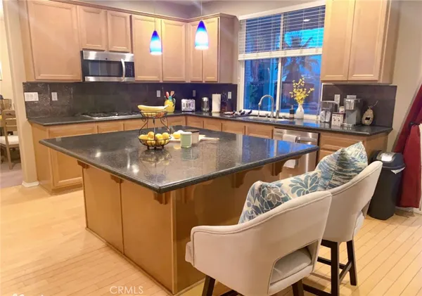 a view of a dining room with furniture and a kitchen area