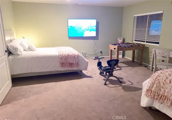 a bedroom with a bed a desk and chair