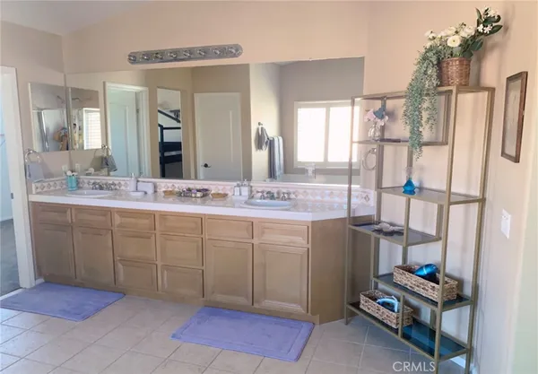 a spacious bathroom with a mirror a sink and a shower