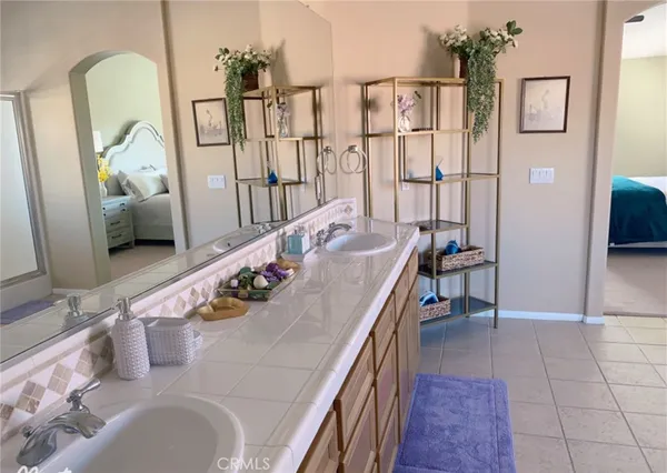 a bathroom with a tub sink and mirror