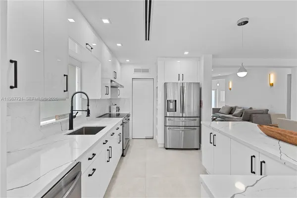 a kitchen with refrigerator and cabinets