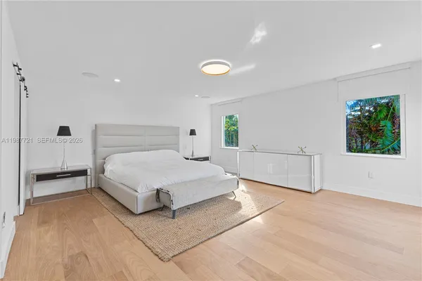 a bedroom with a large bed and a flat screen tv