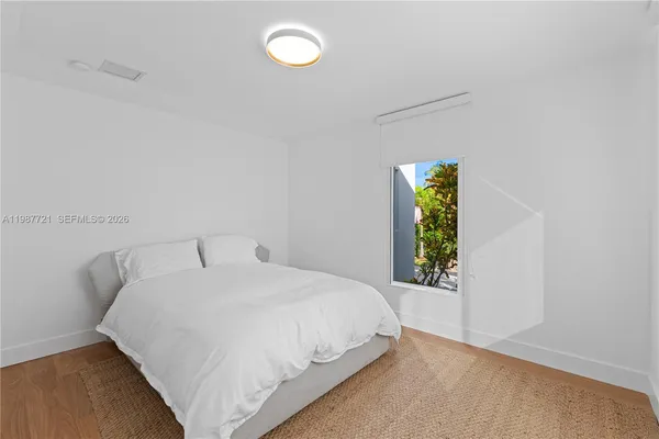 a bedroom with a bed and window