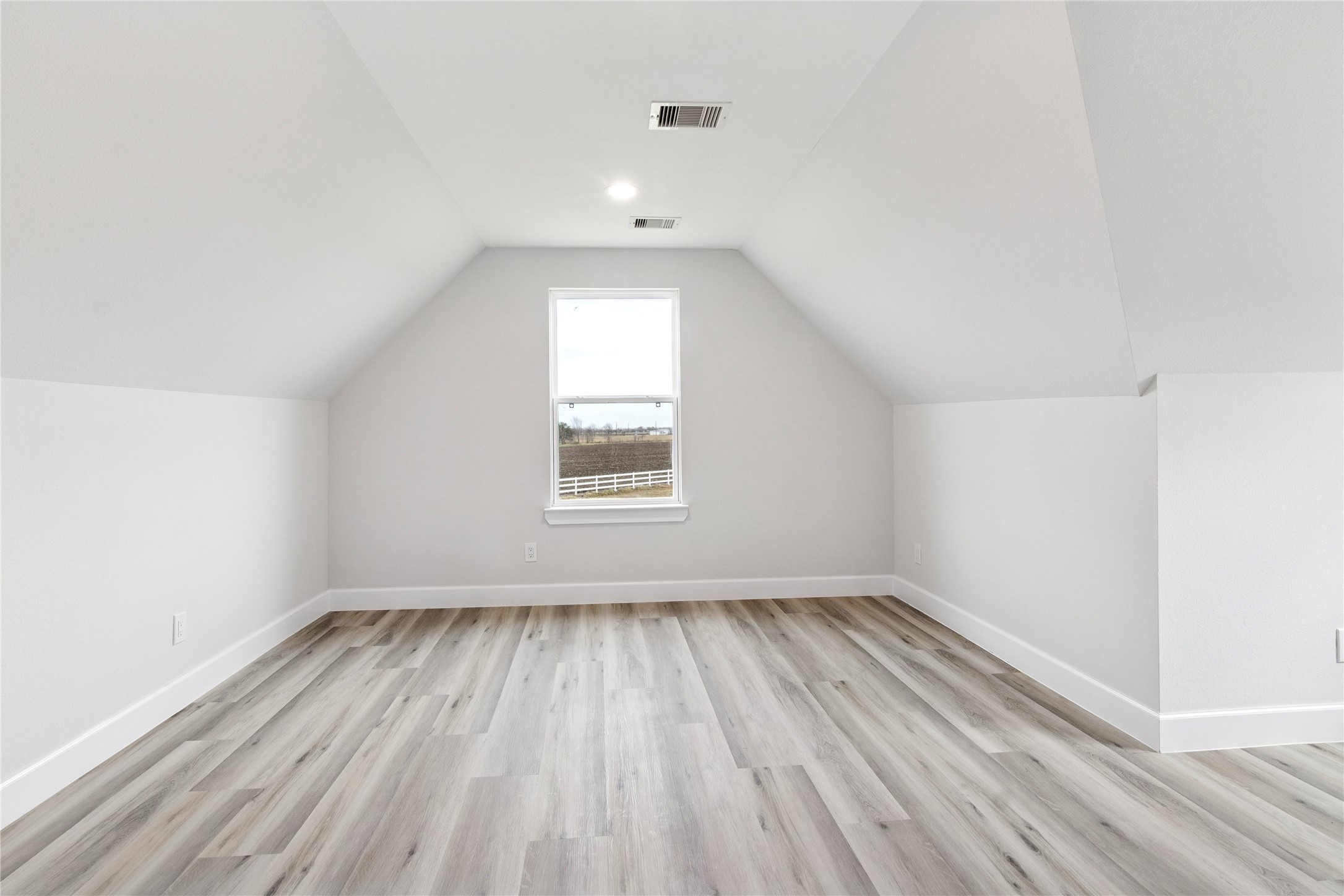 5766 Ward Bend Road Sealy, TX 77474 - Photo 36 of 45 an empty room with wooden floor and windows