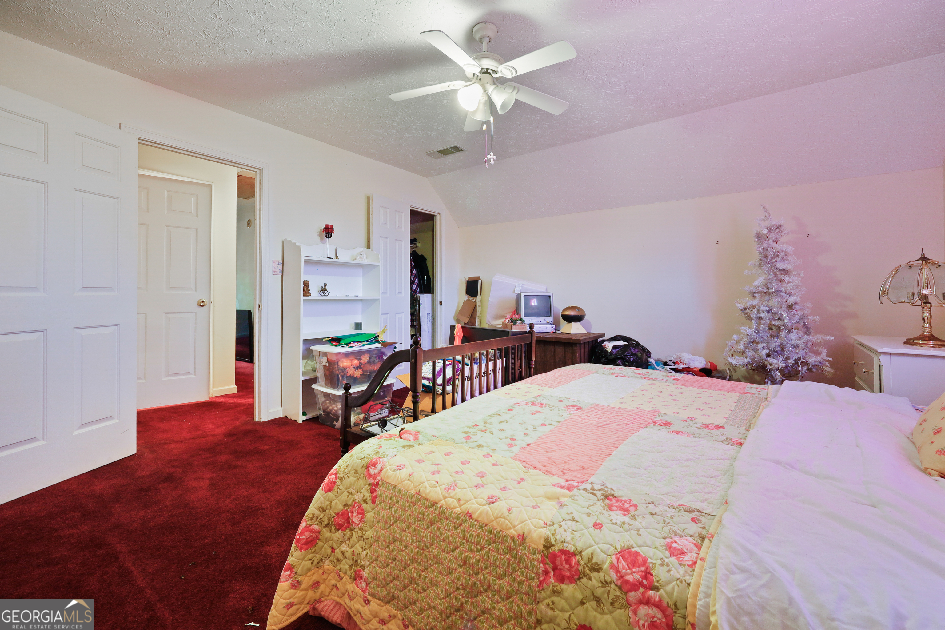 2433 Bear Creek Road Statham, GA 30666 - Photo 27 of 58 a bed room with a bed and a chandelier