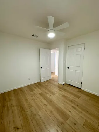 a view of an empty room and wooden floor