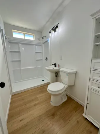 a white toilet sitting next to a bathroom sink