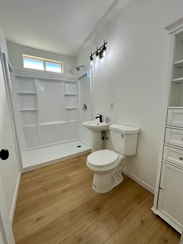 a white toilet sitting next to a bathroom sink
