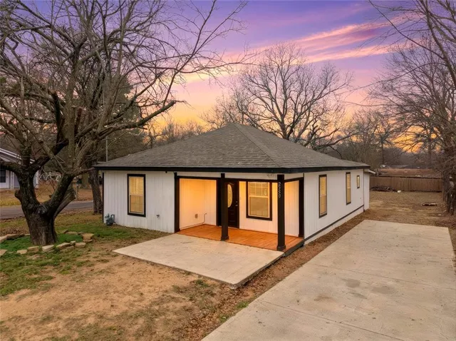 a front view of house with yard and trees