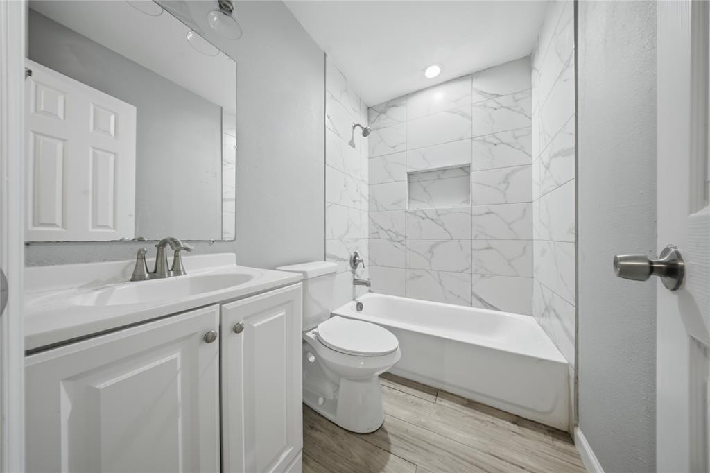 2350 West Cherry Street Paris, TX 75460 - Photo 11 of 18 a bathroom with a bathtub shower sink vanity and toilet