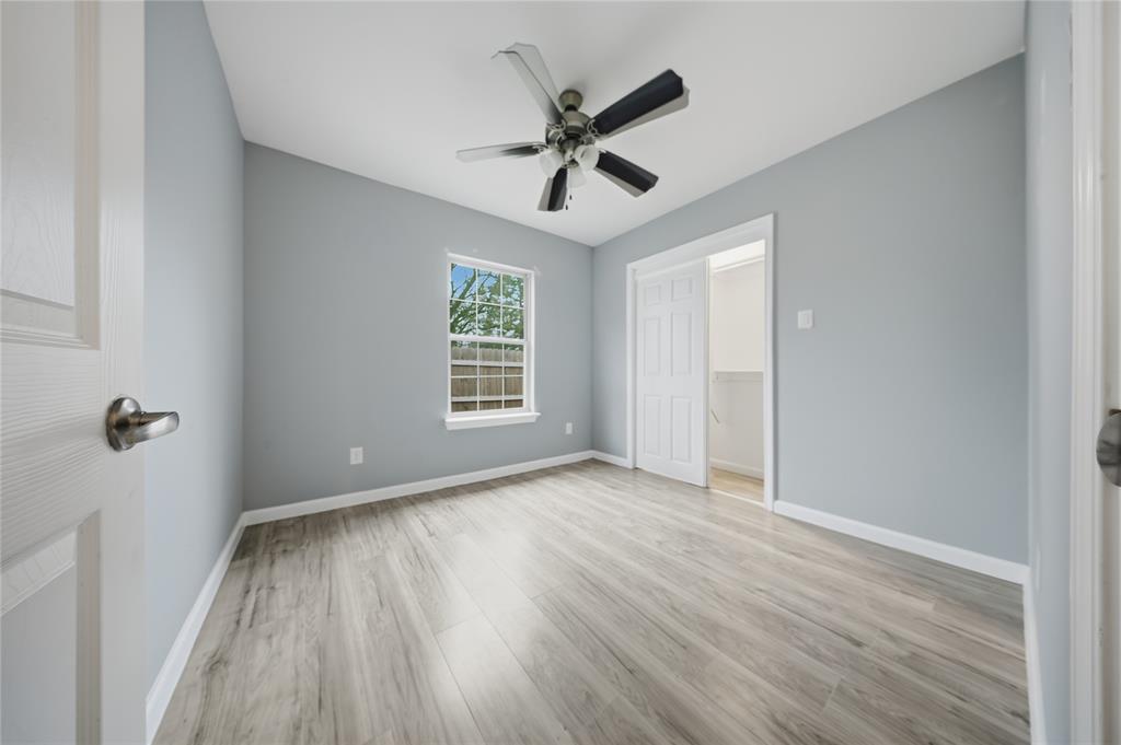 2350 West Cherry Street Paris, TX 75460 - Photo 12 of 18 wooden floor in an empty room with a window
