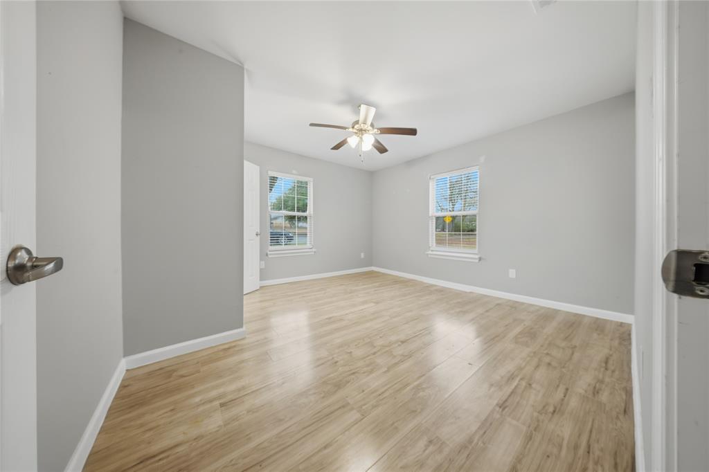 2350 West Cherry Street Paris, TX 75460 - Photo 13 of 18 wooden floor in an empty room with a window