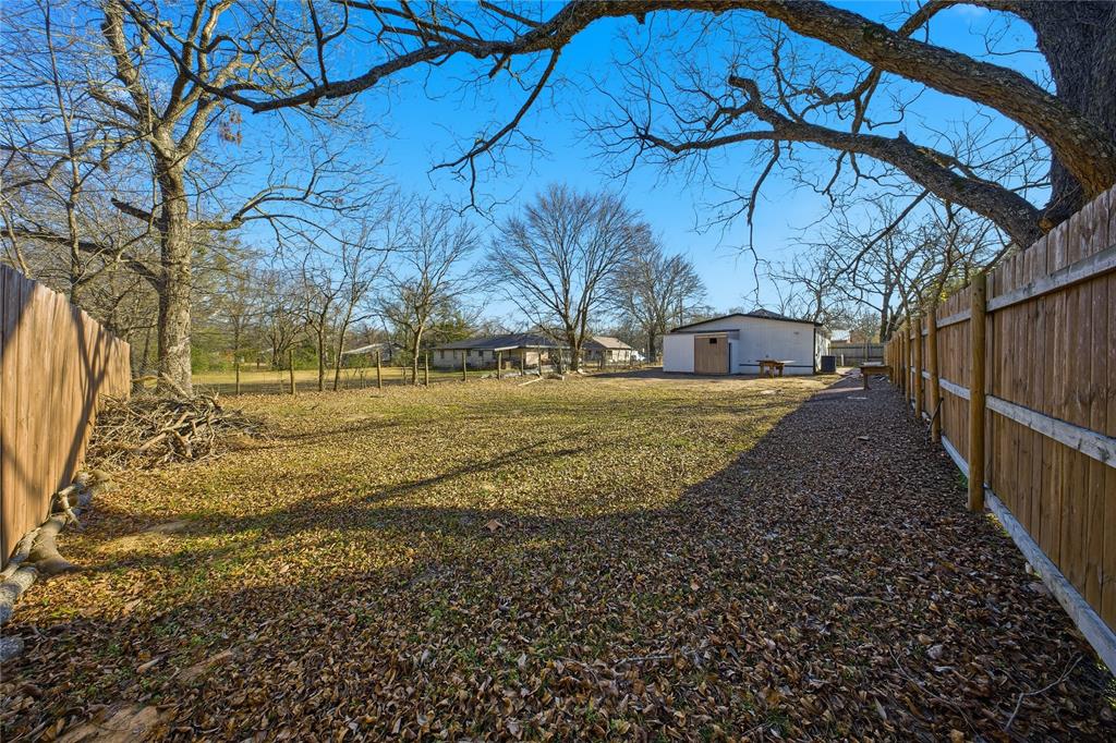 2350 West Cherry Street Paris, TX 75460 - Photo 16 of 18 a view of a yard with wooden fence
