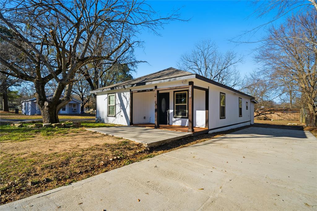 2350 West Cherry Street Paris, TX 75460 - Photo 17 of 18 a front view of a house with a yard