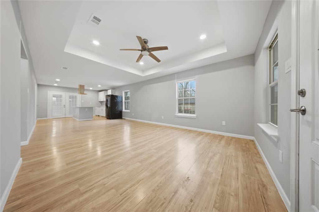 2350 West Cherry Street Paris, TX 75460 - Photo 3 of 18 a view of empty room with wooden floor and window