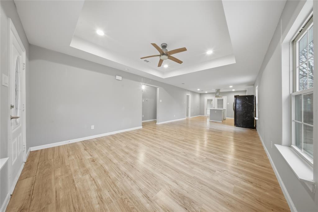 2350 West Cherry Street Paris, TX 75460 - Photo 4 of 18 wooden floor in an empty room with a window