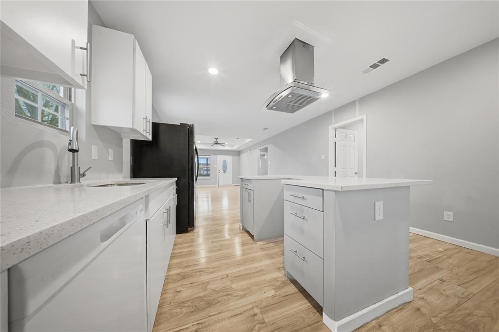 2350 West Cherry Street Paris, TX 75460 - Photo 7 of 18 a kitchen with white cabinets and refrigerator