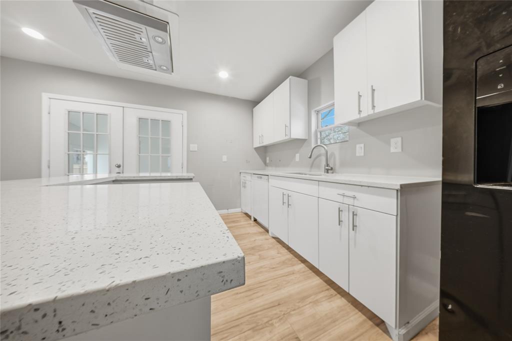 2350 West Cherry Street Paris, TX 75460 - Photo 7 of 18 a kitchen with granite countertop a sink and cabinets