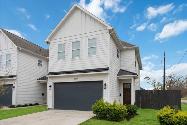 a view of house with a yard and potted plants