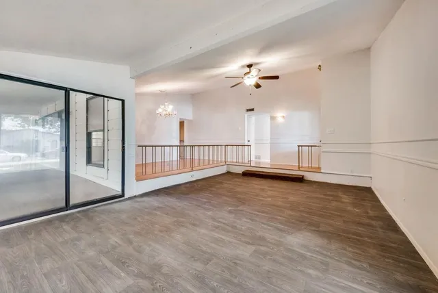 a view of a livingroom with a ceiling fan and window