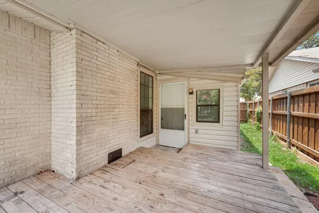 a view of empty room with stairs and wooden floor