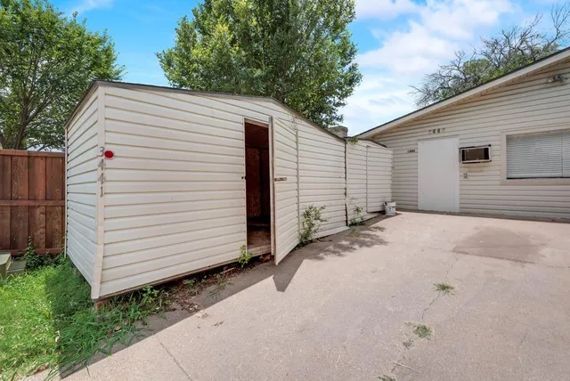 a view of a white house with a yard and garage