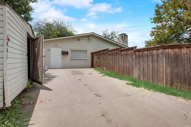 a backyard of a house with wooden fence
