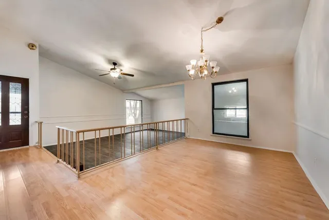 a view of a livingroom with a ceiling fan and window