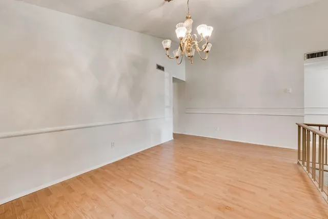 a view of a room with wooden floor