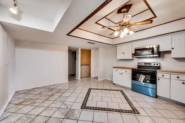 a kitchen with stainless steel appliances granite countertop a stove cabinets and a kitchen island