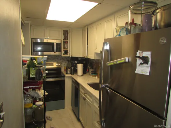 a kitchen with stainless steel appliances a refrigerator stove and microwave