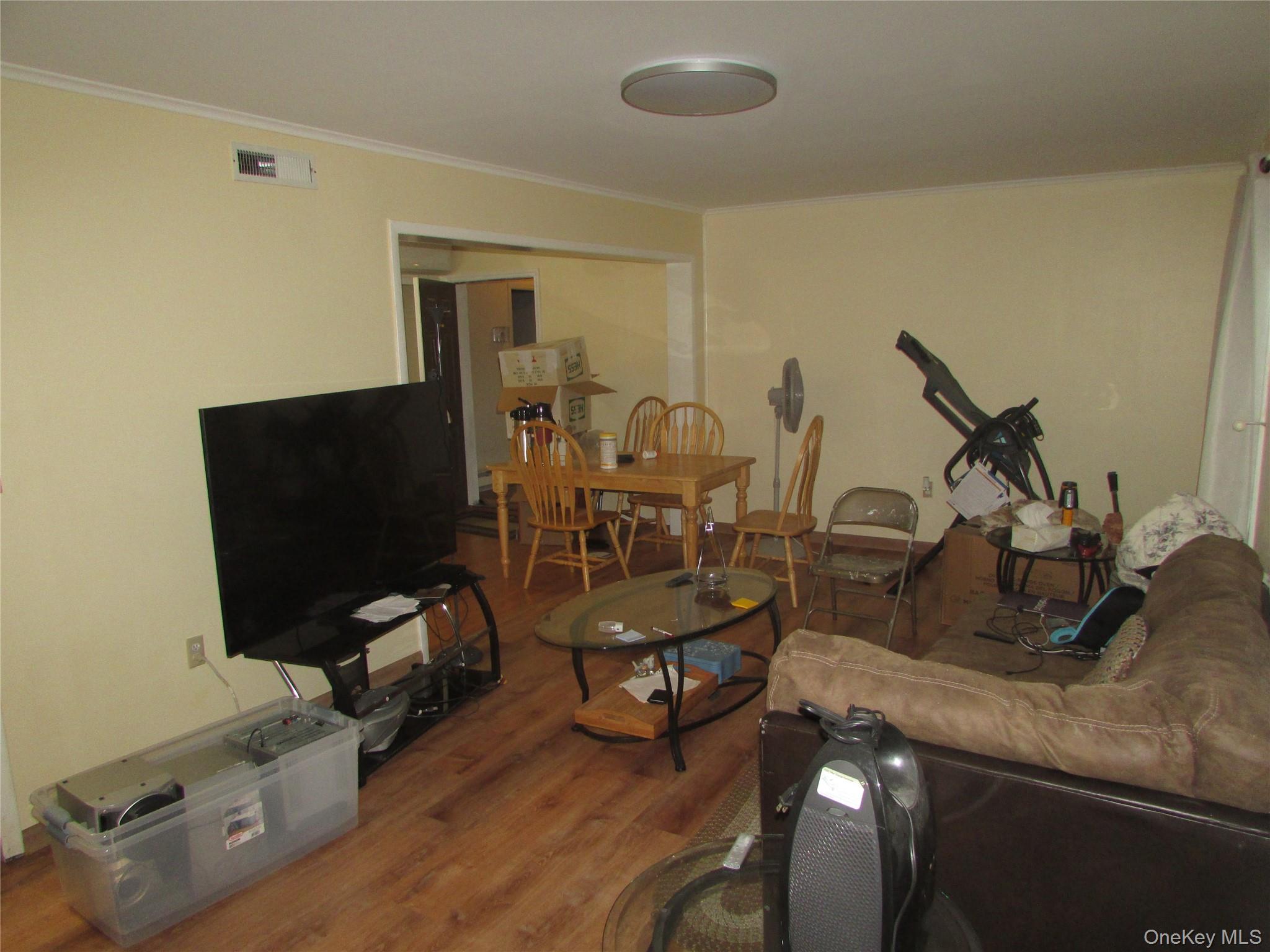 32 Hurlihe Street, Unit C Poughkeepsie, NY 12601 - Photo 4 of 8 a view of a livingroom with furniture and a flat screen tv