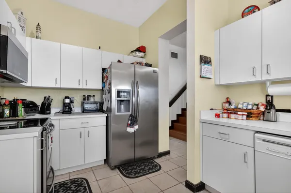 a kitchen with stainless steel appliances a refrigerator sink and cabinets