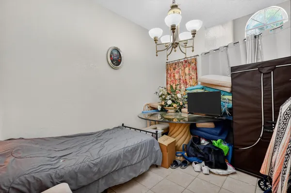 a bedroom with bed and a window