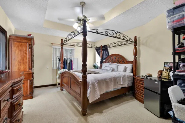 a view of bedroom with a bed and a dresser