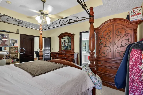 a bedroom with a bed a couch and dresser