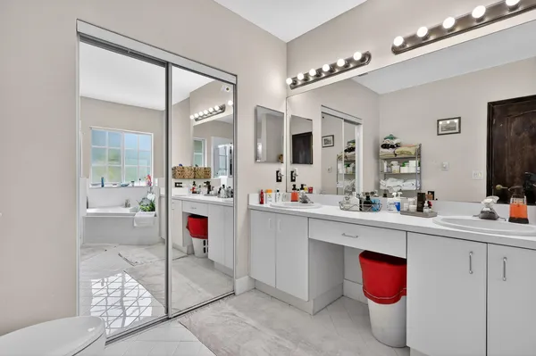 a bathroom with a bathtub a sink a vanity and a shower