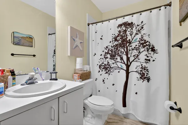 a bathroom with a sink toilet and shower