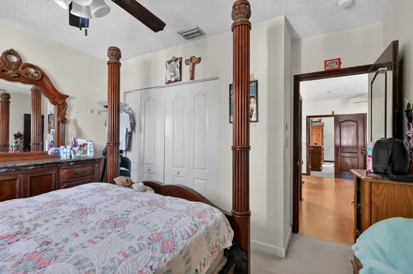 a bedroom with a bed and a mirror