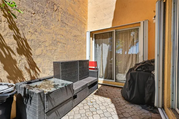 a view of a chair and table in backyard