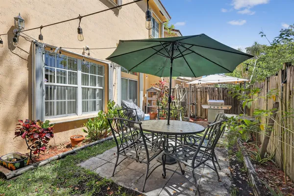 a view of a chair and table in the patio