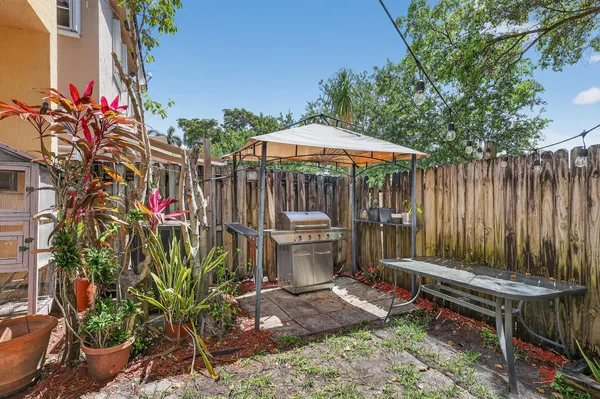 a view of an outdoor sitting area with furniture and umbrella